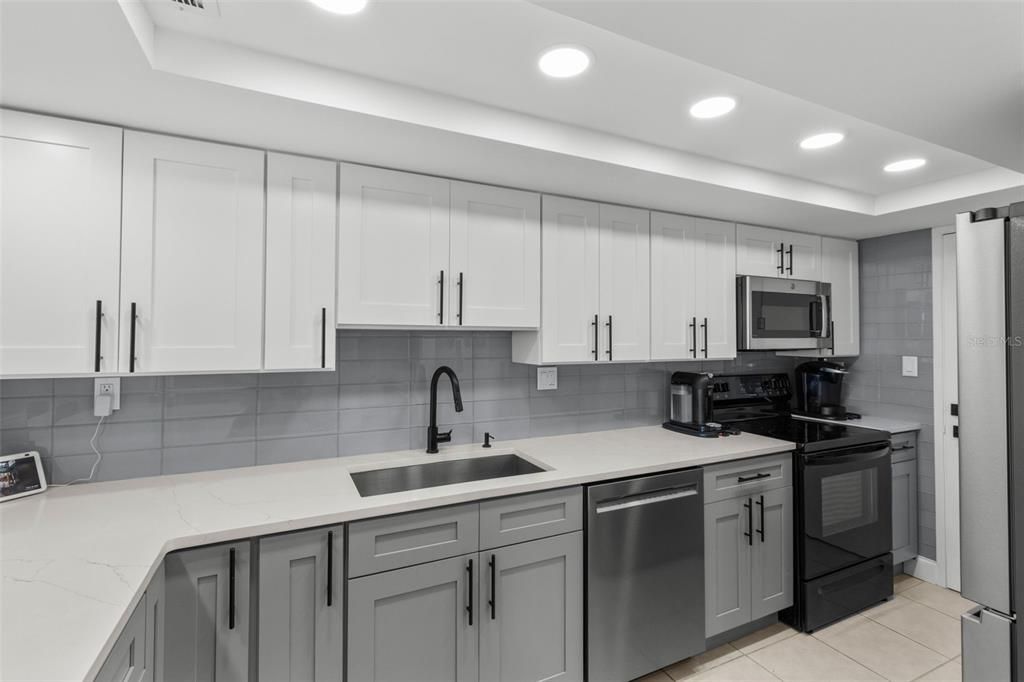 The tile backsplash, convection microwave with air fryer, and brand-new refrigerator (purchased in November) make this kitchen truly ideal.