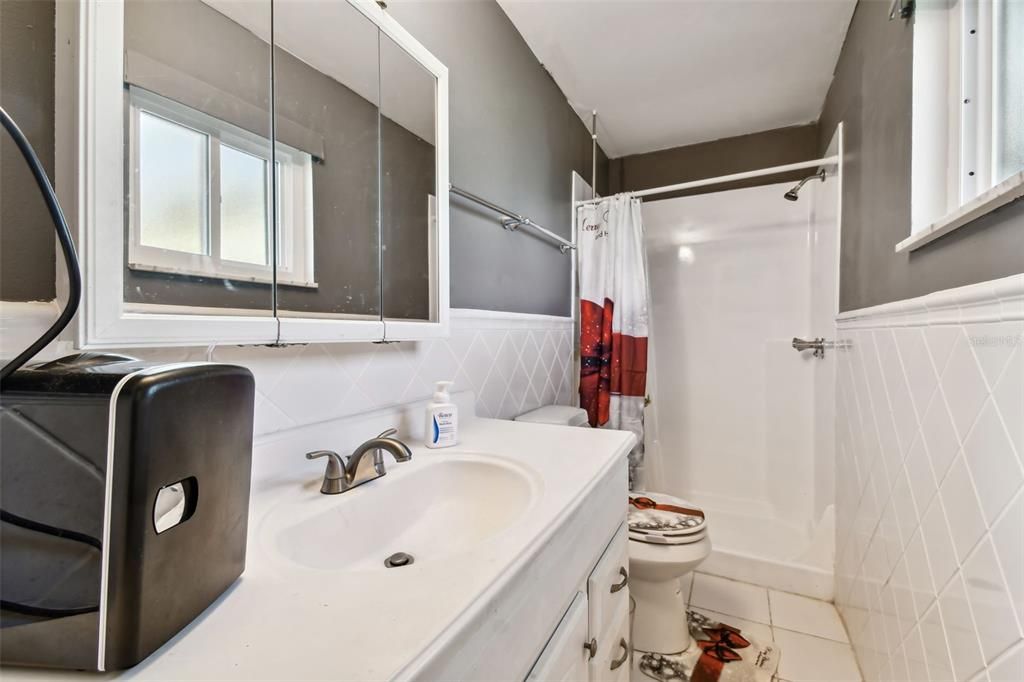 En-suite with sink and walk-in shower.