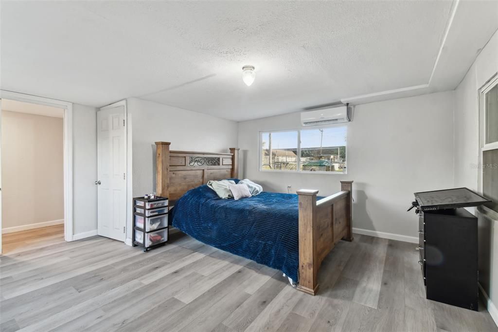 In-law suite master bedroom with luxury vinyl flooring.