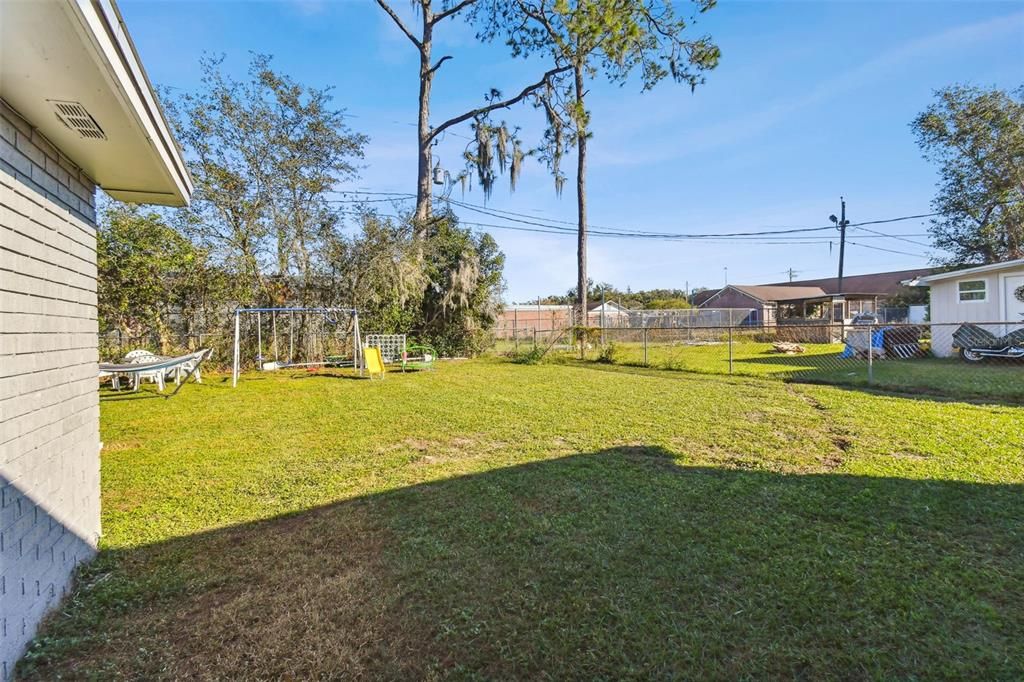 Fully fenced back yard with ample room for a pool if so desired.