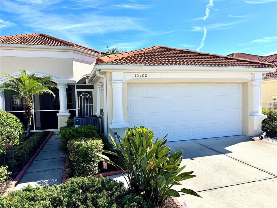 Lush landscaping and a 2 car garage