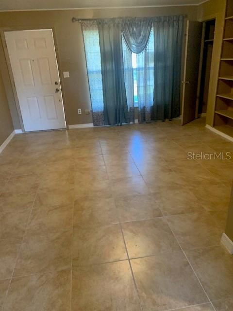 Living Room with Shelving and Beautiful Tile Flooring.