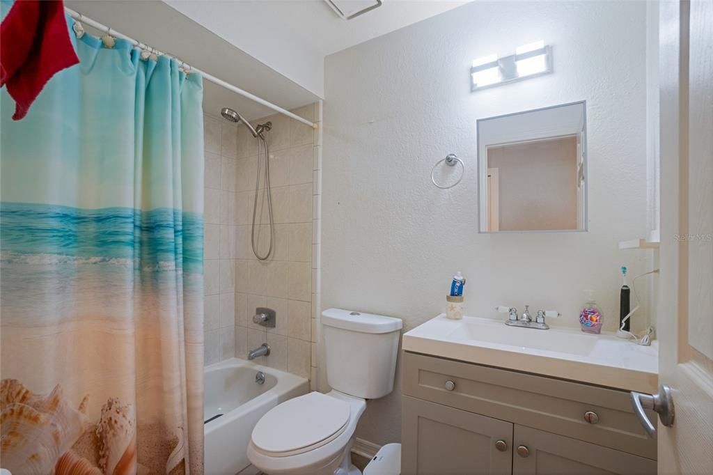 Bathroom 2 - jack and jill access to bedroom 2 and living room. Bathtub with updated vanity and flooring.