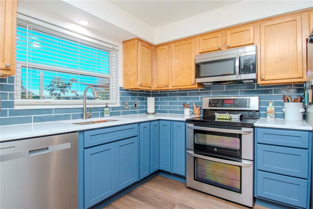 Remodeled kitchen, updated flooring and tile backsplash.