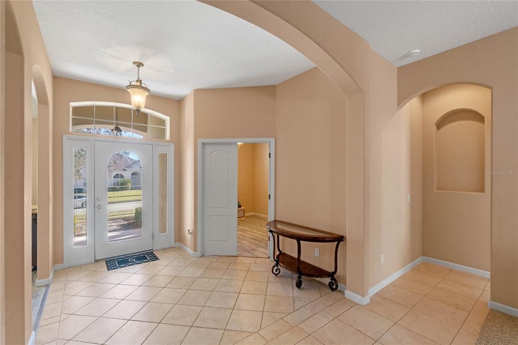 Foyer. Door to the right of the front door is the office. Door to the right of the office is the primary bedroom suite.