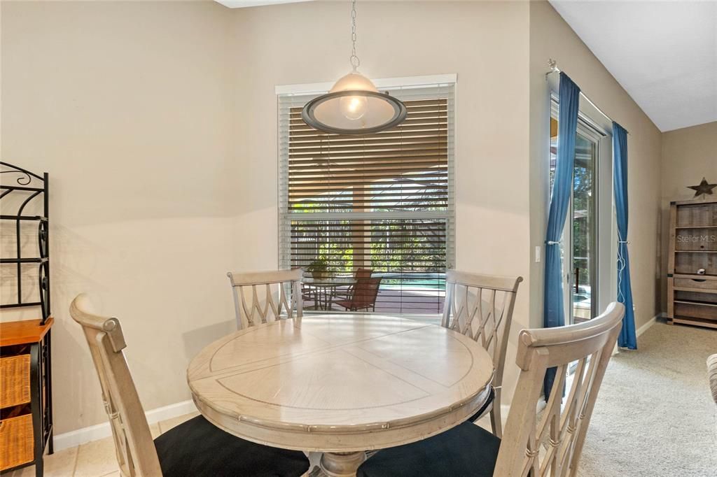 Eating space in the kitchen overlooking the pool area.