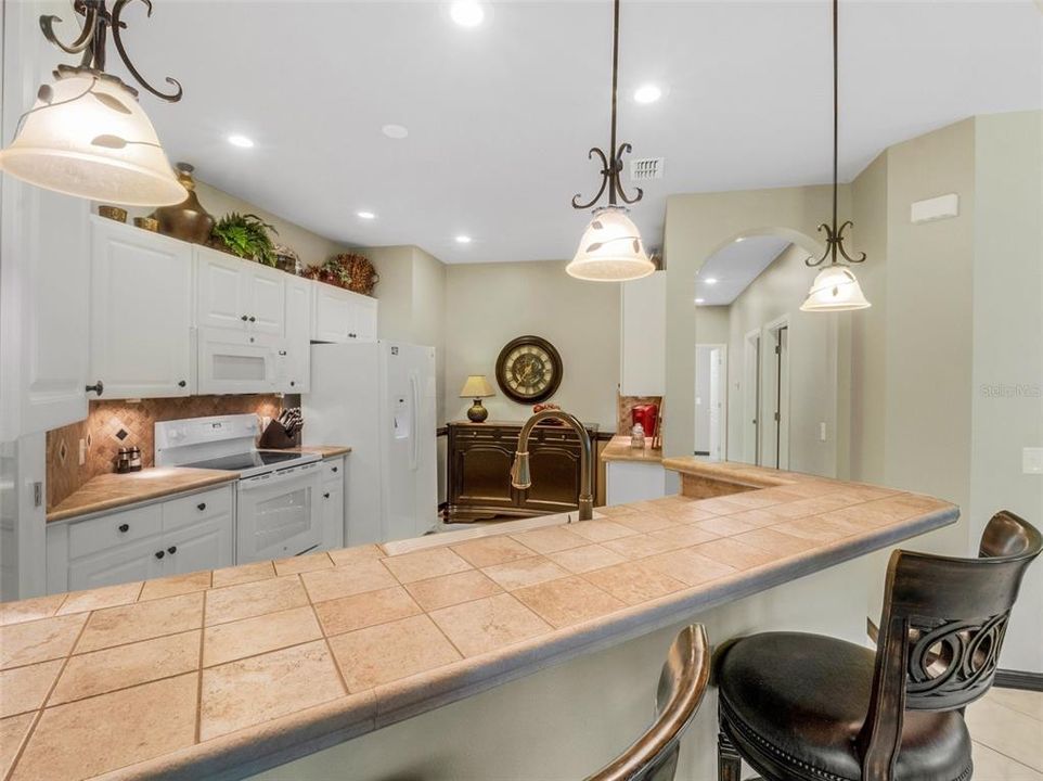 Pendant lights accent the breakfast bar