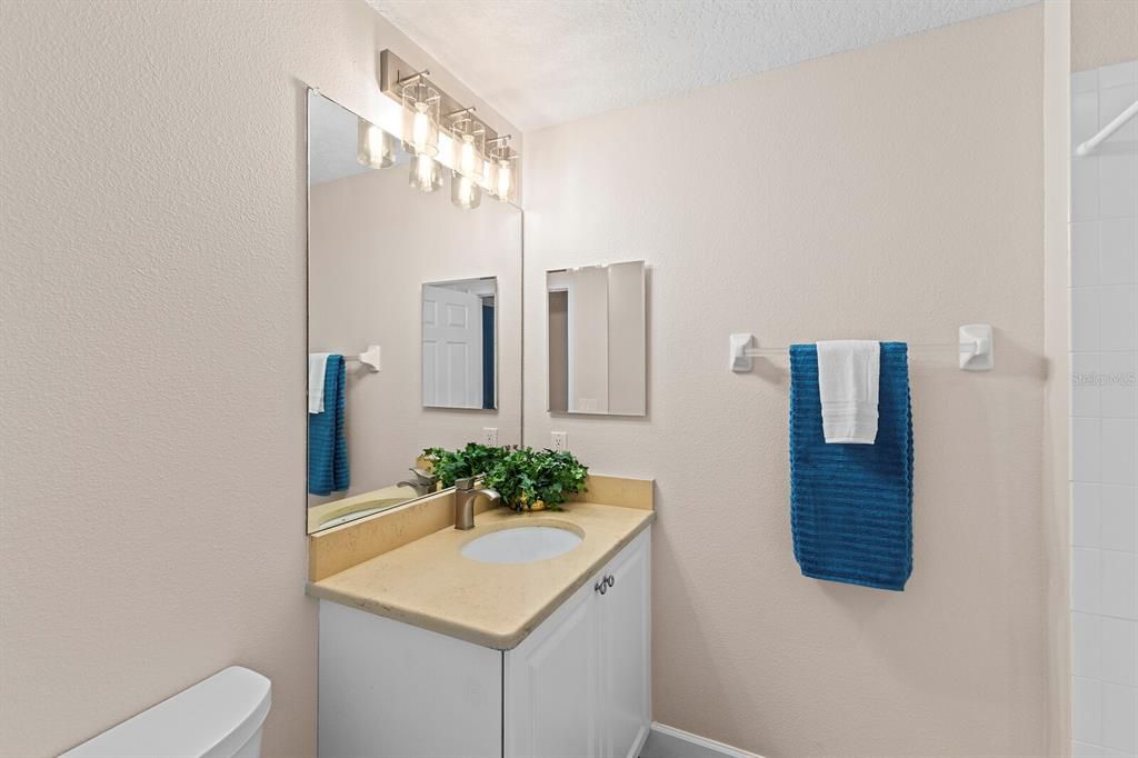 Full guest bathroom with update light fixture