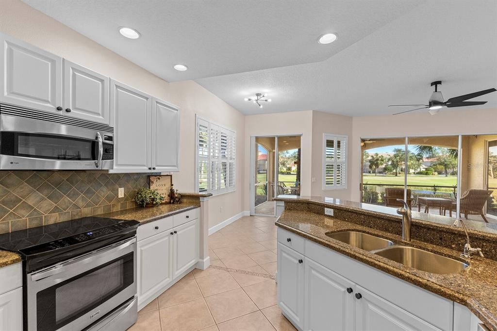 White kitchen with granite countertops and gas range