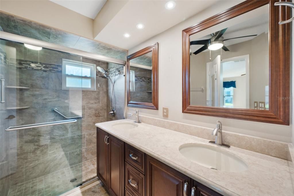 Primary bath with updated shower, double vanity with mirrors