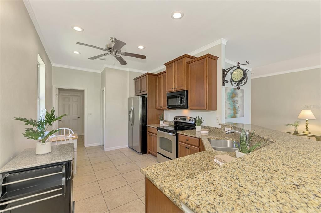 The kitchen features Stainless appliances, granite countertops, crown molding and 42" wood cabinetry