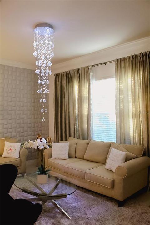 Living Room with window treatments and wall panel and light