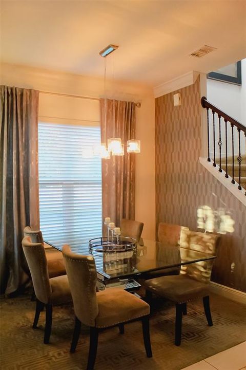 Dining Room with window treatment, wall paper and light