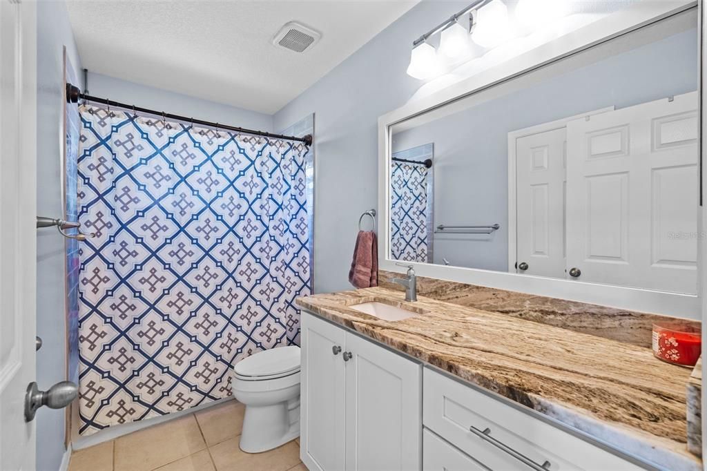 Bathroom 2 with tub and shower surround