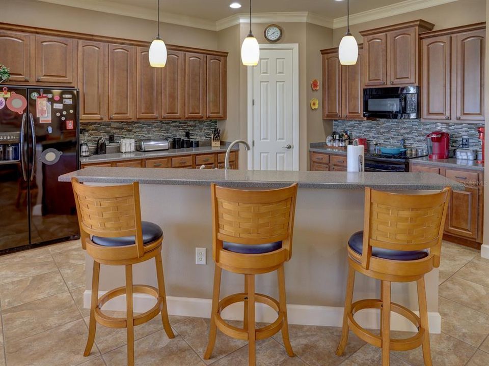 Kitchen. Hard surface countertops and wood cabinets.