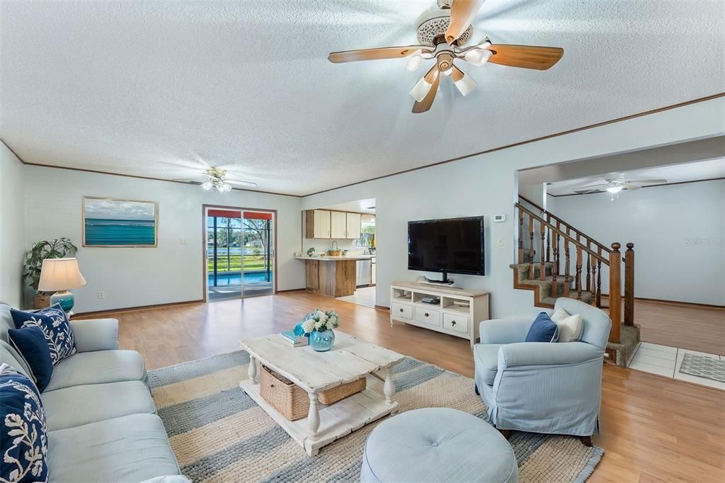 Virtual staging.  Living room with view to Lake Gleason - through pool deck