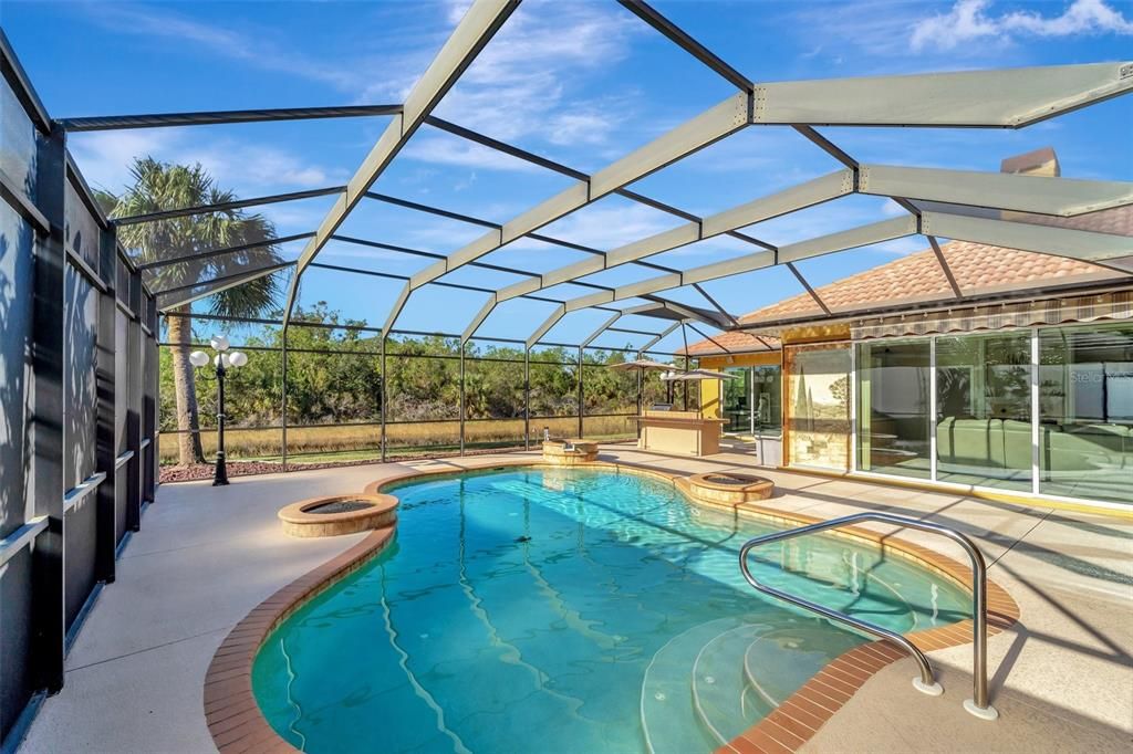 Look at this pool area and outdoor kitchen with Lake views