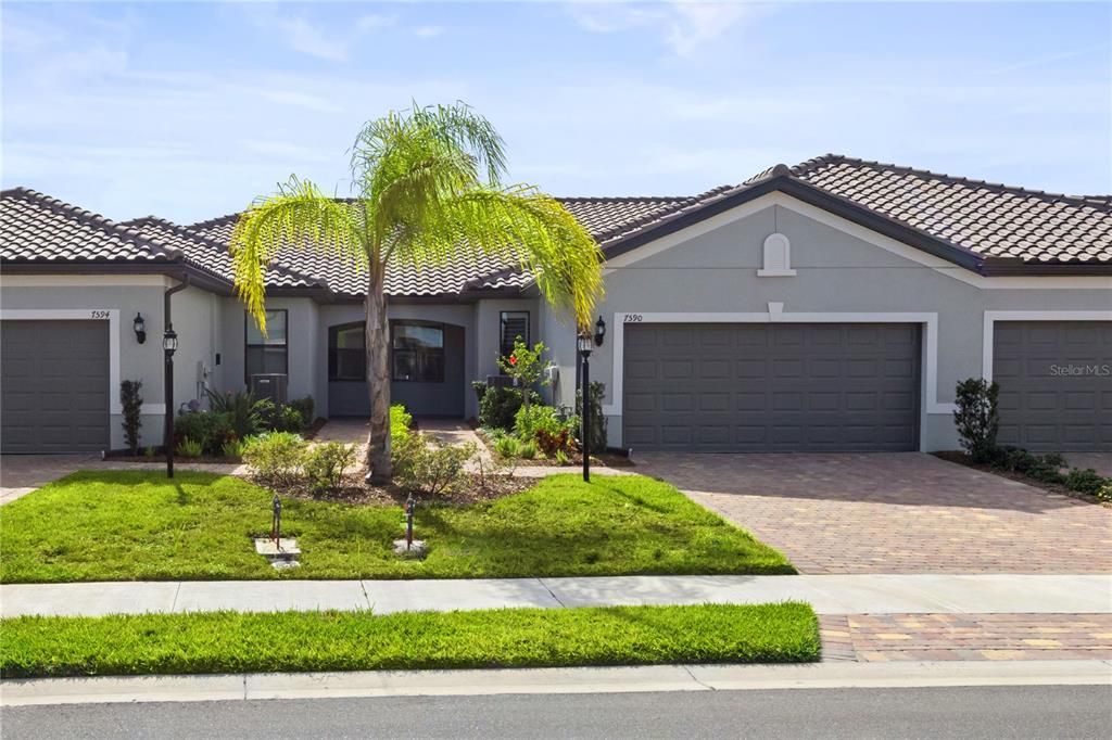 Lush landscaping surrounds the home on the front and back.