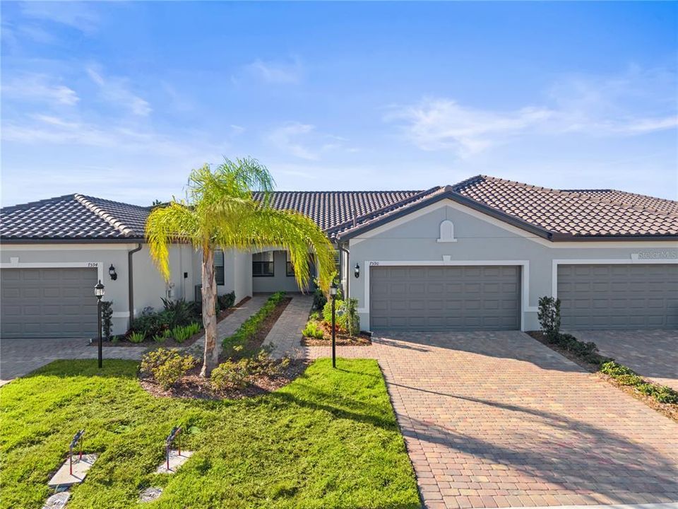 Front elevation showing the driveway, two car garage, and front entryway.