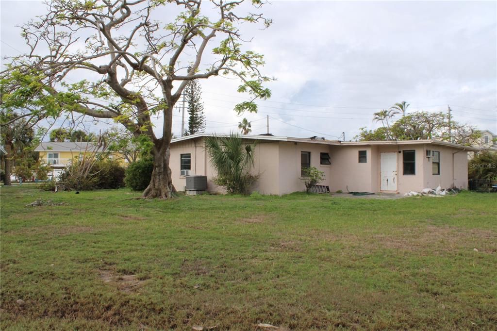 Rear view of property and back yard showing depth of the property