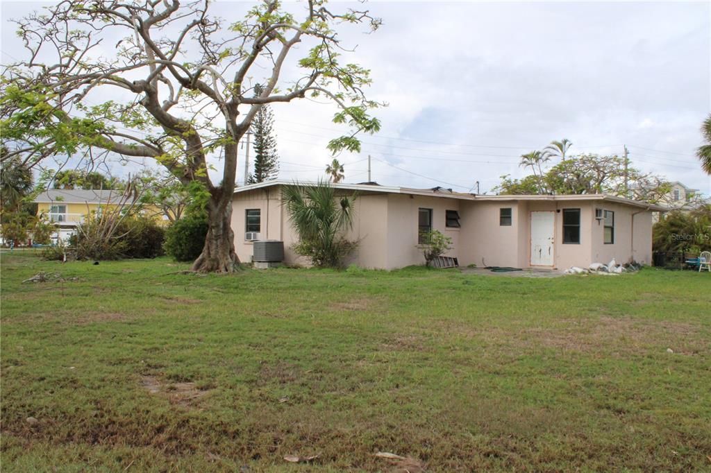 Rear view of property and back yard showing depth of the property