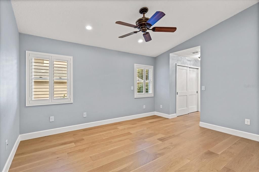 Luxurious primary suite with volume ceilings