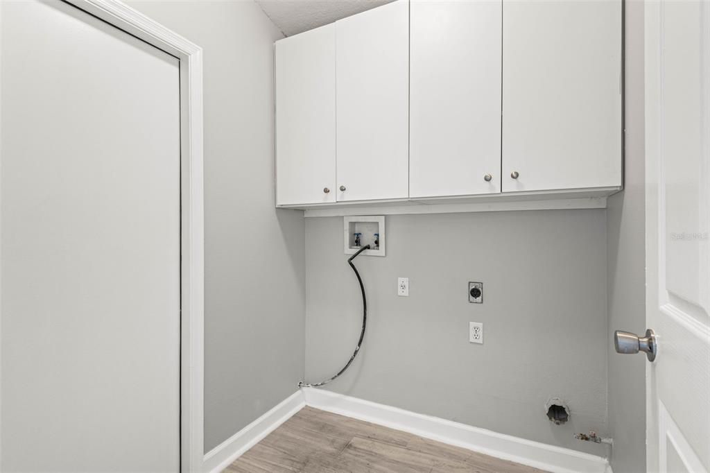 Interior laundry room adjacent to kitchen