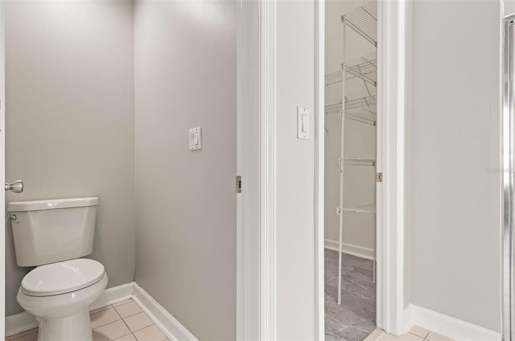 Primary bathroom and access to walk-in closet