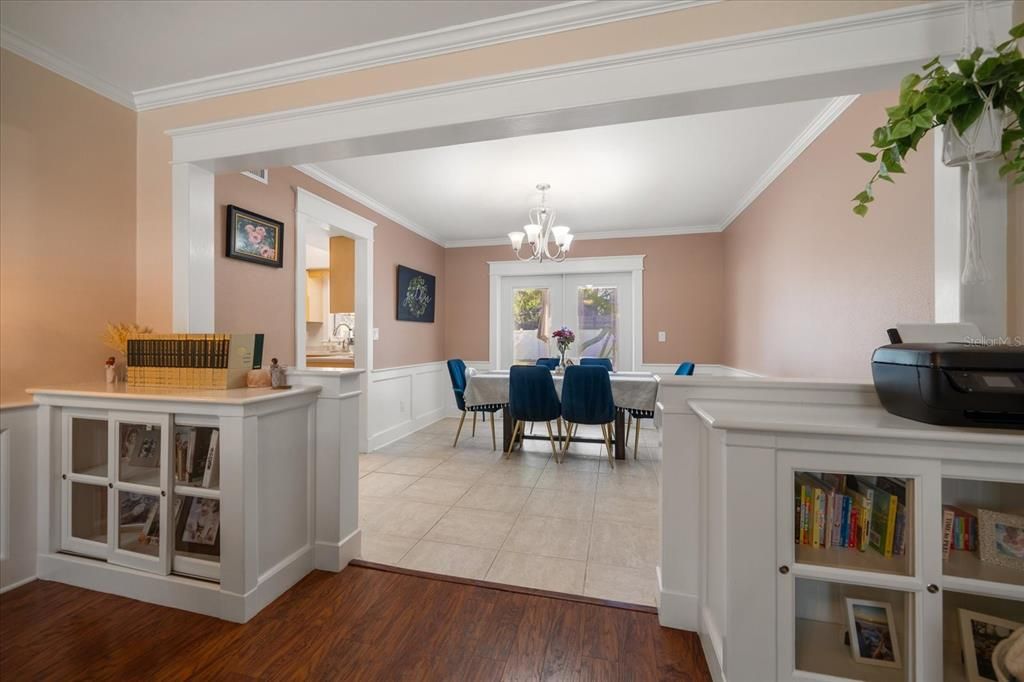 Dining area has detailed millwork and view of  pool area.