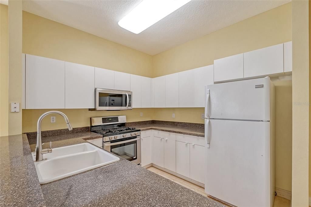 Kitchen has double sink and plenty of storage & counter space