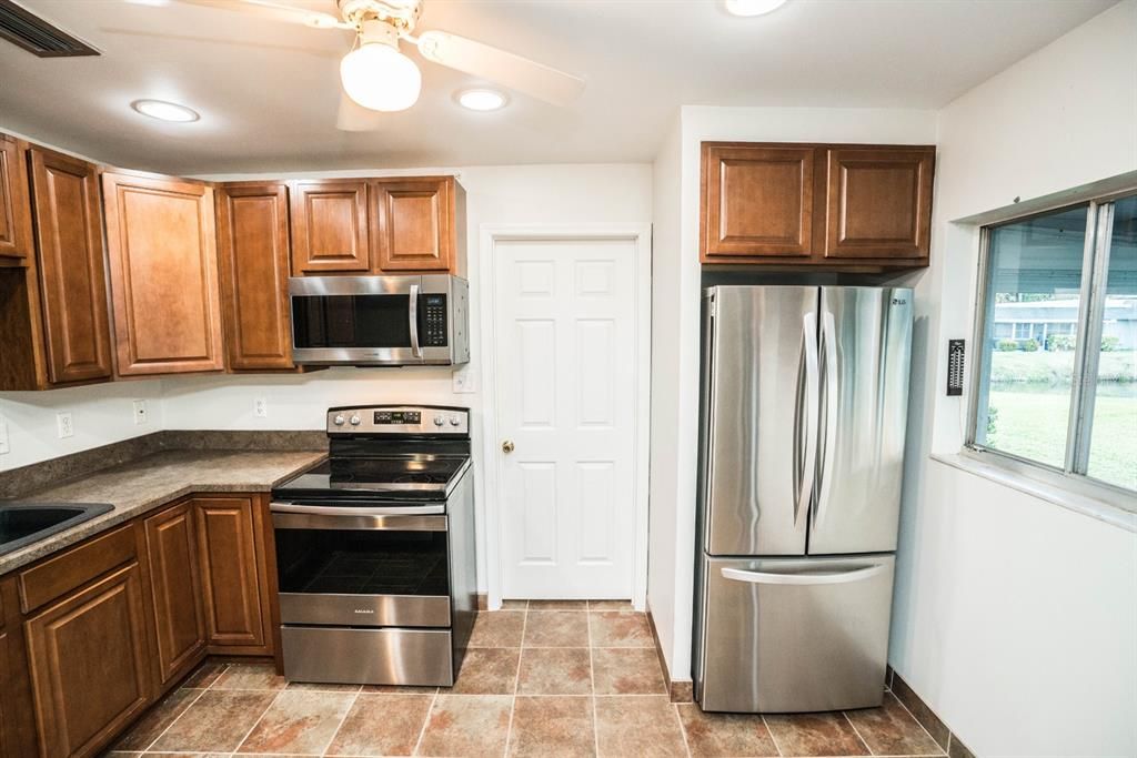 Kitchen with stainless steel appliances and new refrigerator