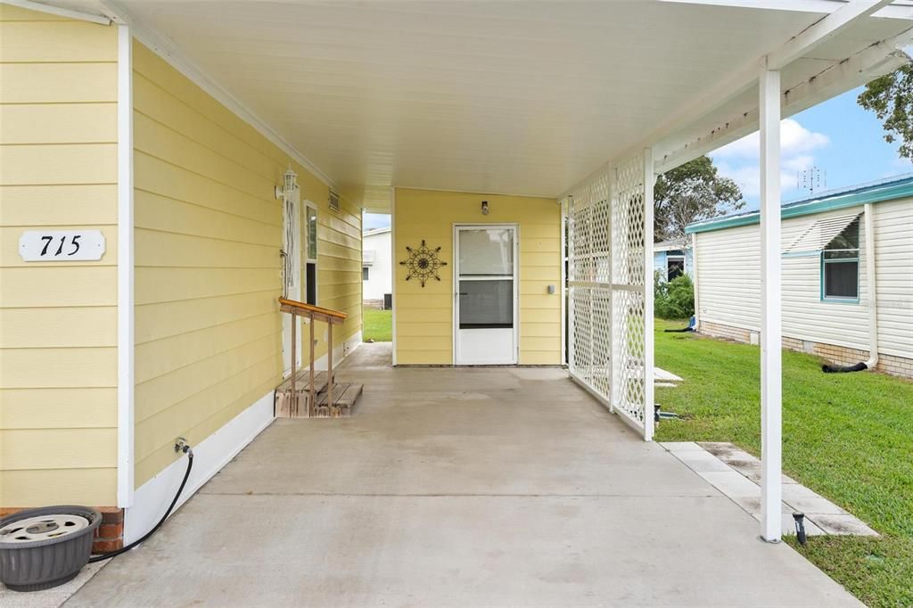 Carport Area with entrance on left and Storage/Workshop at end of carport area