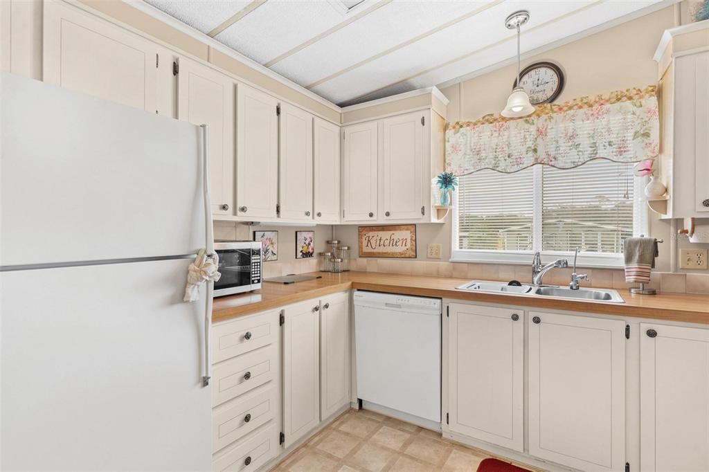 Kitchen looking at entry way, Utility area behind closet doors, Closet pantry on right, eat-in area on left