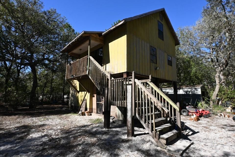 FRONT OF HOME FACES SOUTH TOWARDS THE RIVER