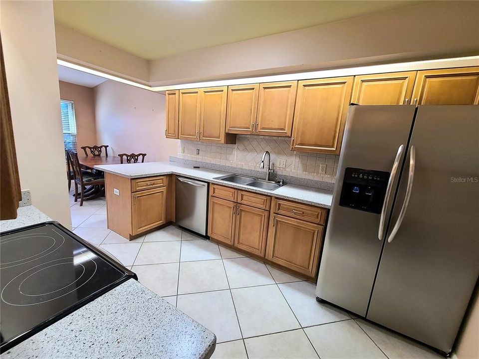 Kitchen with wood cabinets, stainless appliances and tile floors that was remodeled only a few years ago