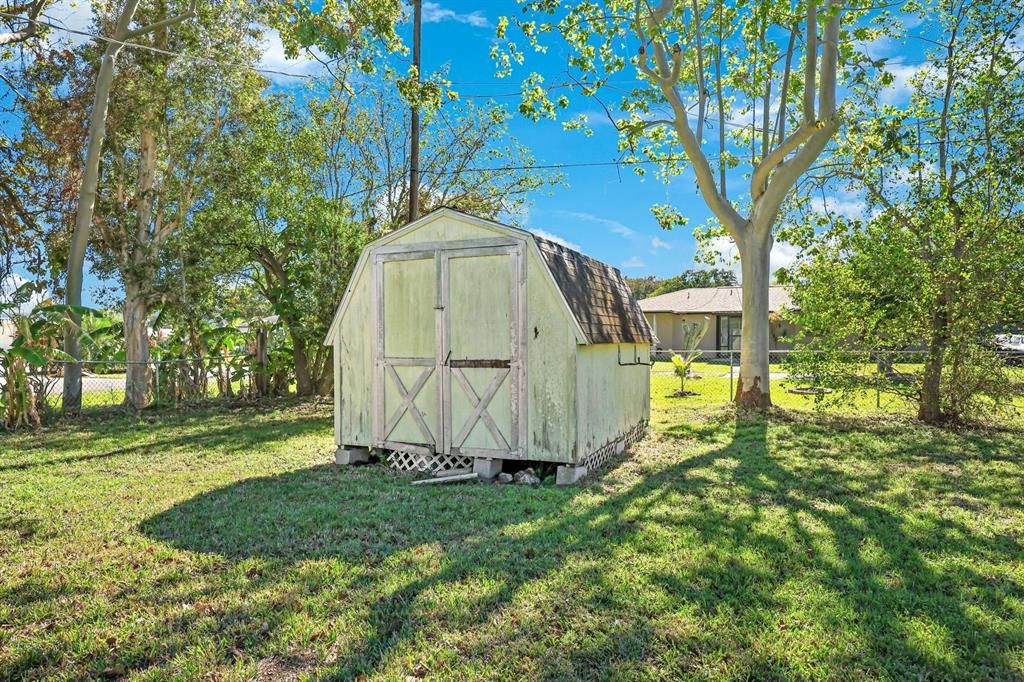 View of outbuilding with a yard