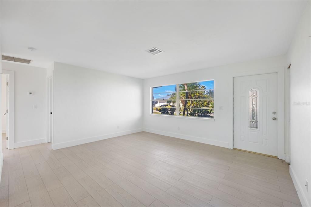 Empty room with light hardwood / wood-style floors