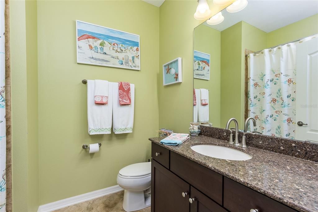 Guest bathroom has tub and shower combination.