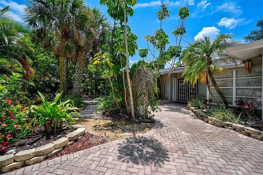 Lush Tropical gardens surround this beautiful home.