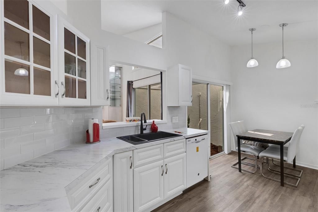 Glass cabinet doors & luxurious farm sink.