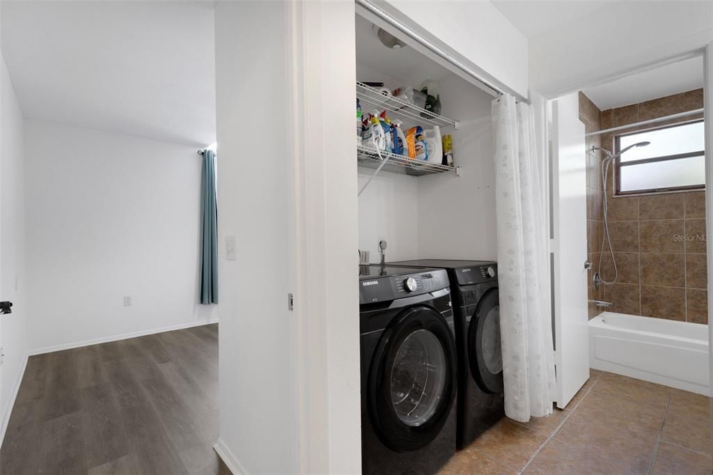 New washer and dryer. Guest room, vanity and bathroom with tub.