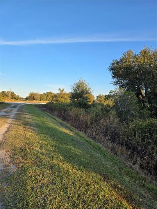 Front showing corner at east end of property on NW 274th St.