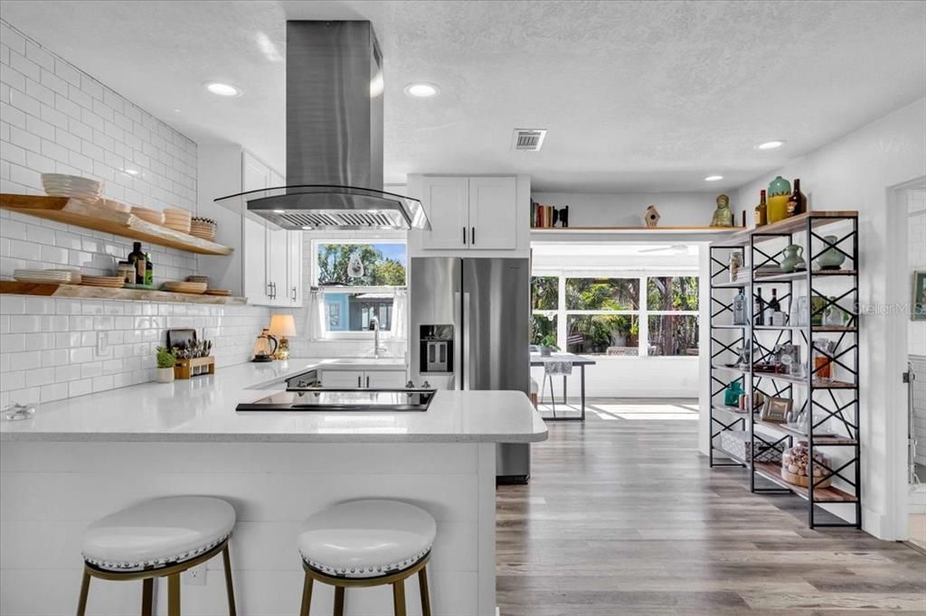 Light and bright open floor plan kitchen, living, sunroom