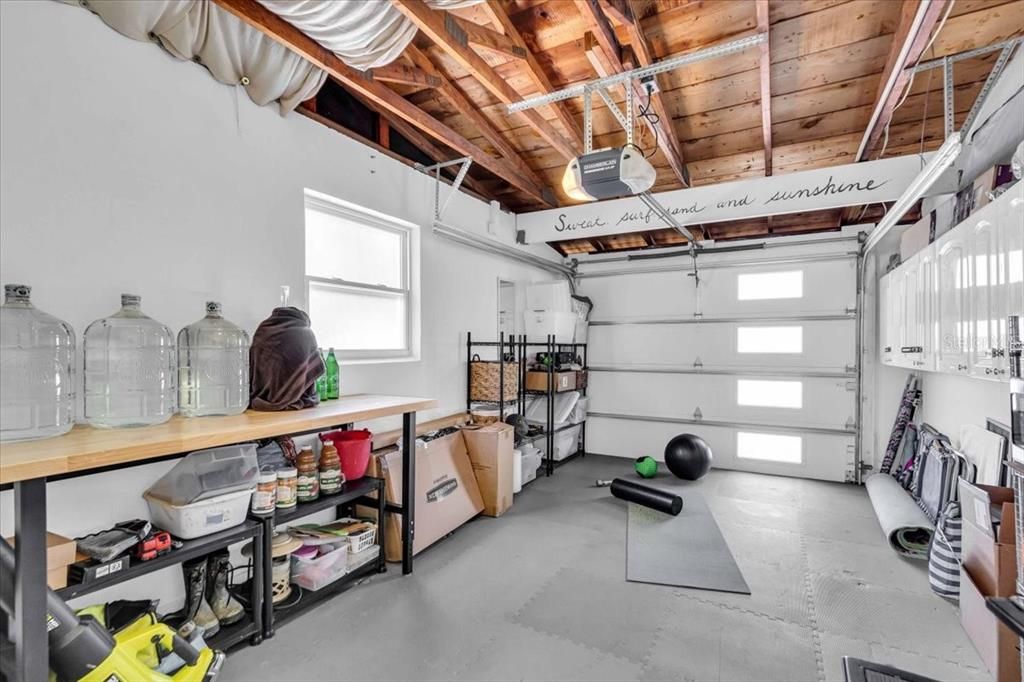 Single car garage with hurricane proof double insulated mid century modern door.  Floor equipped with rubber Interlocking pads great for an exercise area, room for a work bench, car or turn this into the third/master bedroom with ensuite bath.