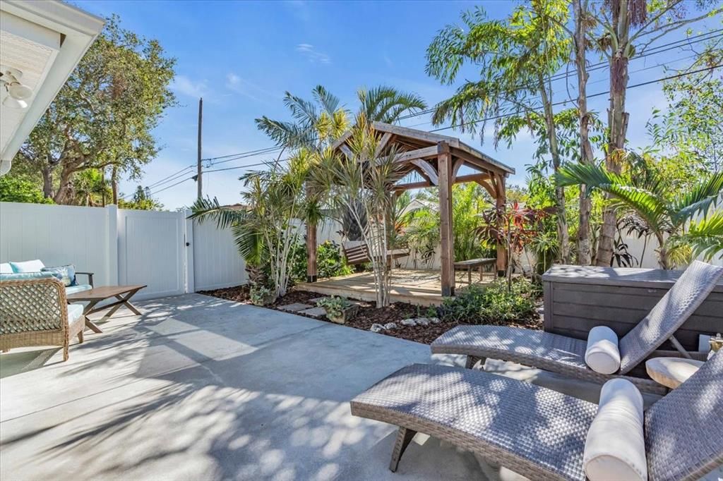 Lush landscaping around this sweet gazebo, perfect for enjoying an afternoon book and ice tea.