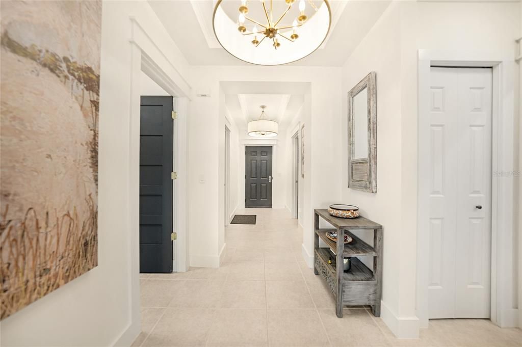 Entrance of condo. Lavish light fixture in foyer