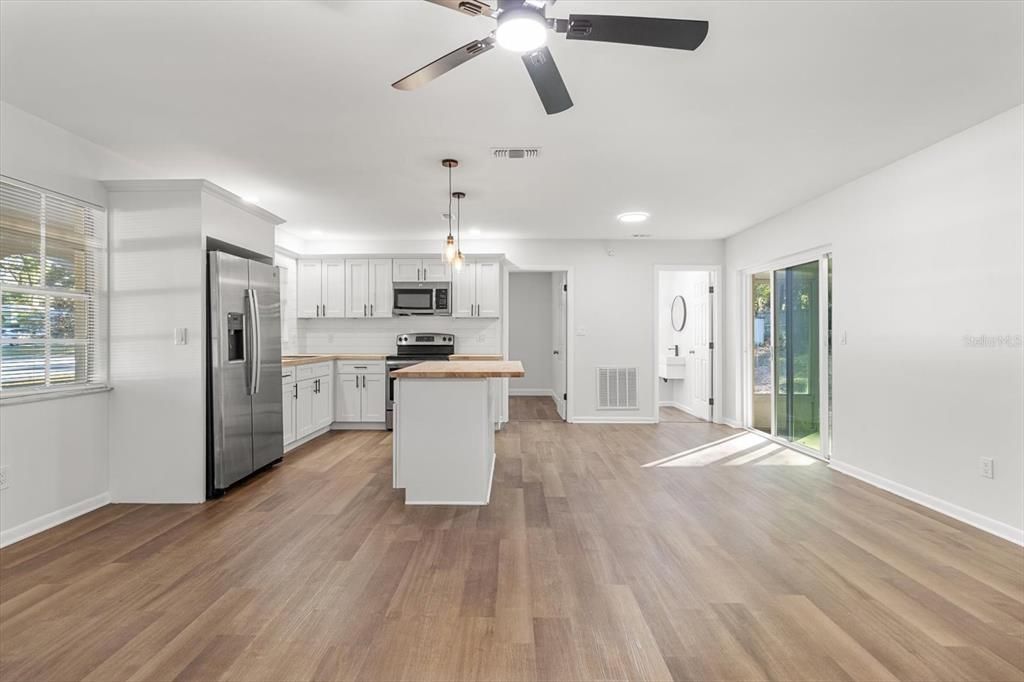 View from Front Door Toward the Kitchen/ Dining Area w/ Slider to the Enclosed Porch