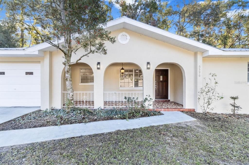 Covered Front Porch w/ Elliptical Arches & Wrought Iron Railings