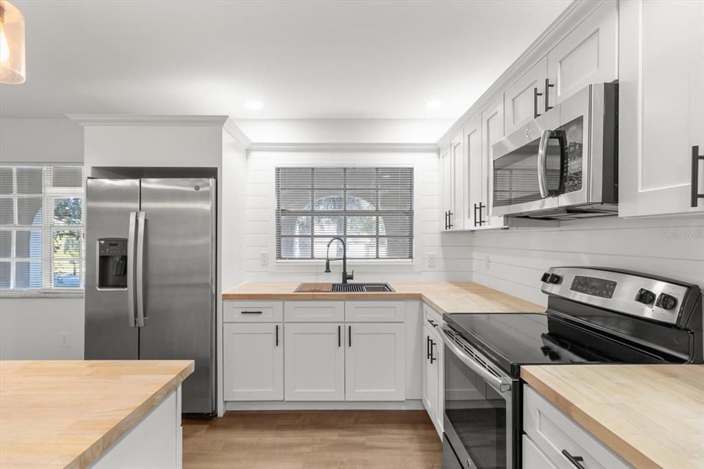 Renovated Kitchen with NEW: White Shaker Cabinets w/ Crown Molding & Lighting, Butcher Block Countertops, Shiplap Backsplash & Newer S/S Appliances