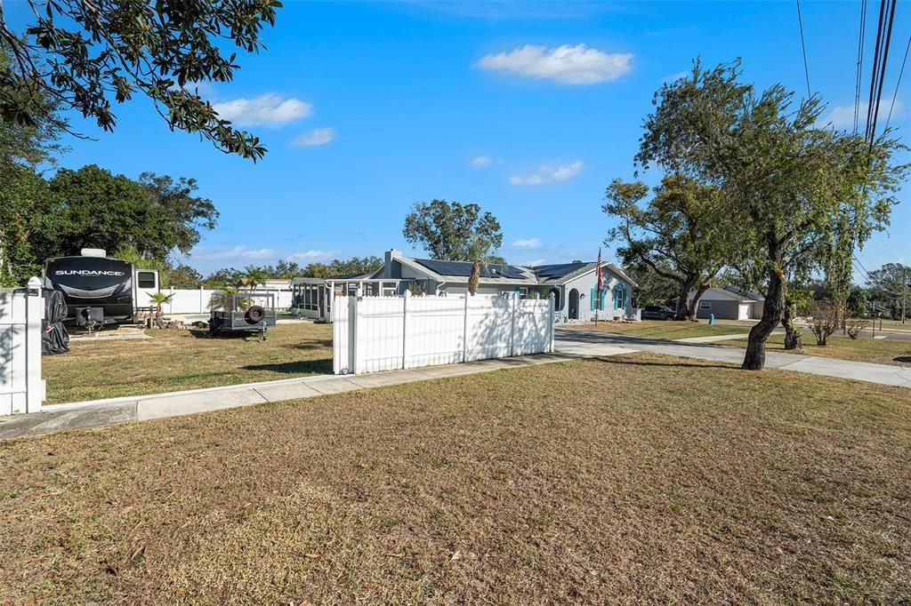 Back yard entry with rolling gate perfect to easily back in an RV